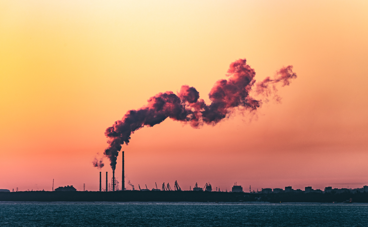 Smoke from the chimneys of an industrial plant at sunset.