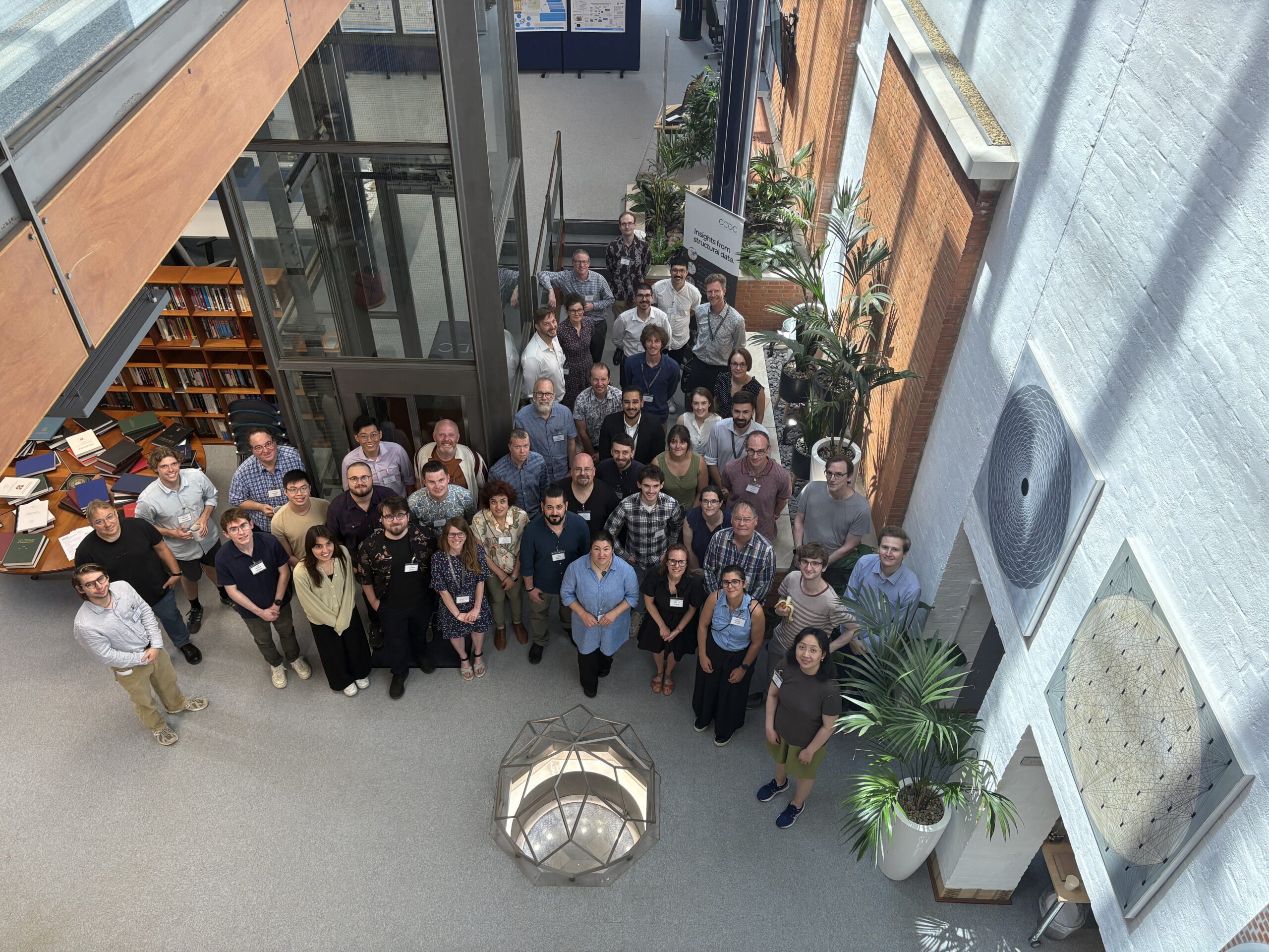 Group of people on a lower level building looking up at the camera.