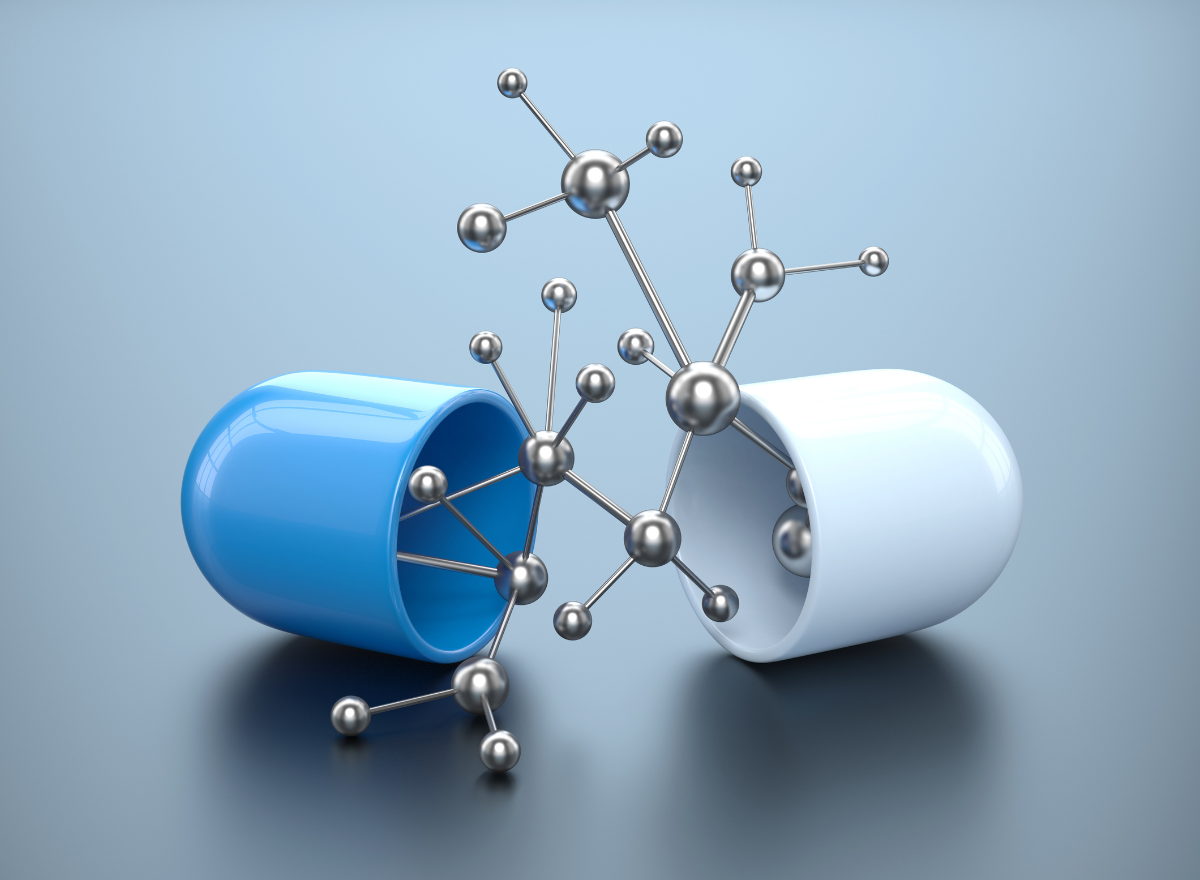 A blue and white open capsule with a molecule made of metal atoms and bonds.