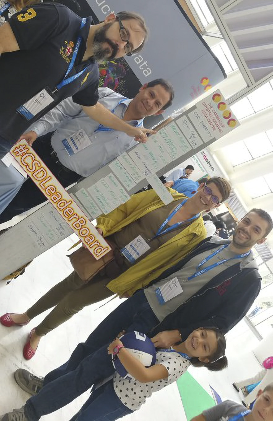 Group of people standing next to the CSD-Leaderboard at ECM33.