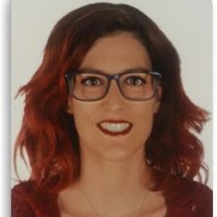Woman with glasses smiling.