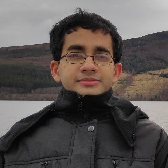 Young man with glasses in the mountains.