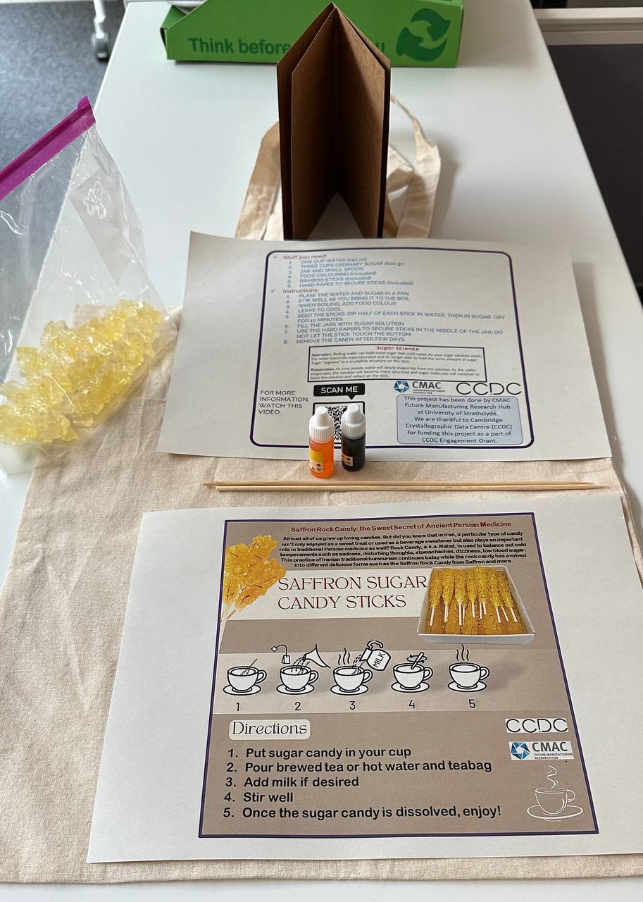 Two papers, two small bottles and a yellow crystal candy.