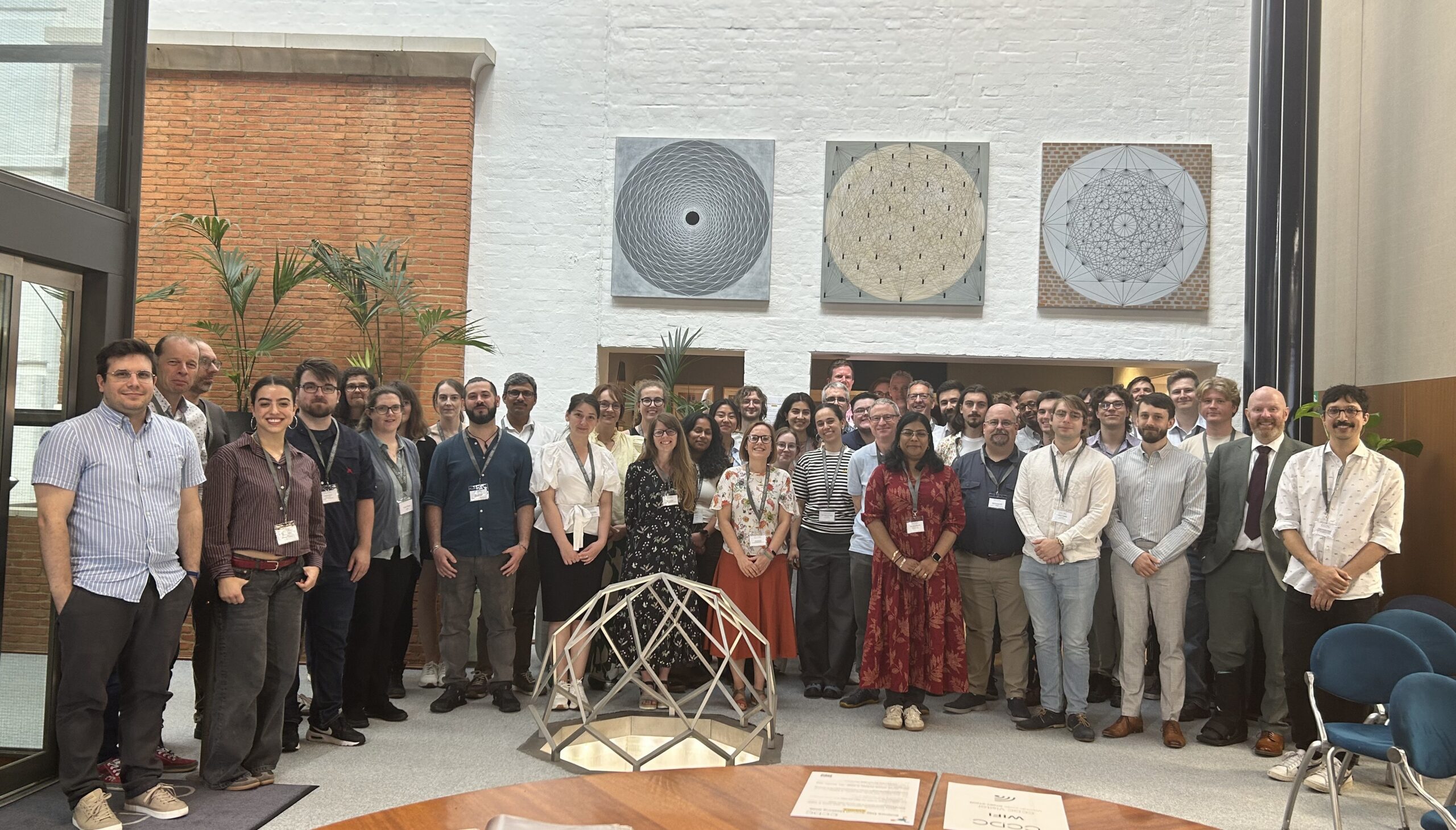 Participants of the CCDC Science Day 2026 gathered for a group picture in the CCDC library, with students, supervisors, and researchers standing around a crystallographic sculpture.