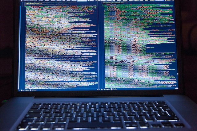 A laptop screen full of Python code.